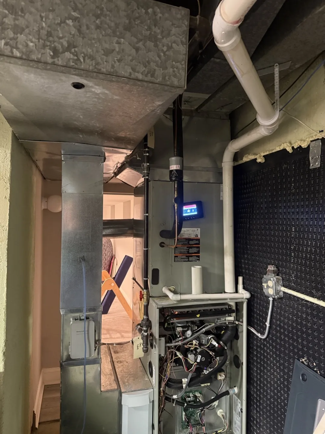 The furnace with its service panel off, showing the original return connection.